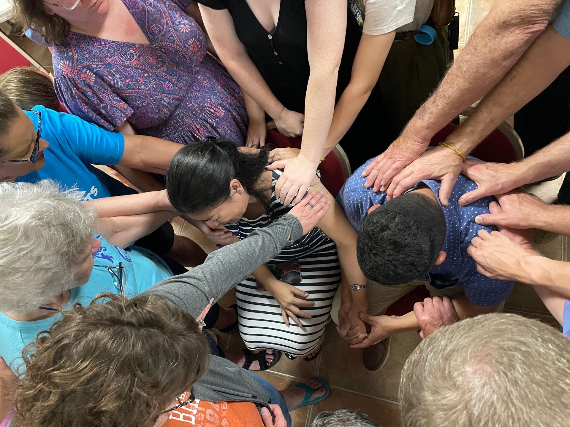 A group of people are holding hands in a circle.