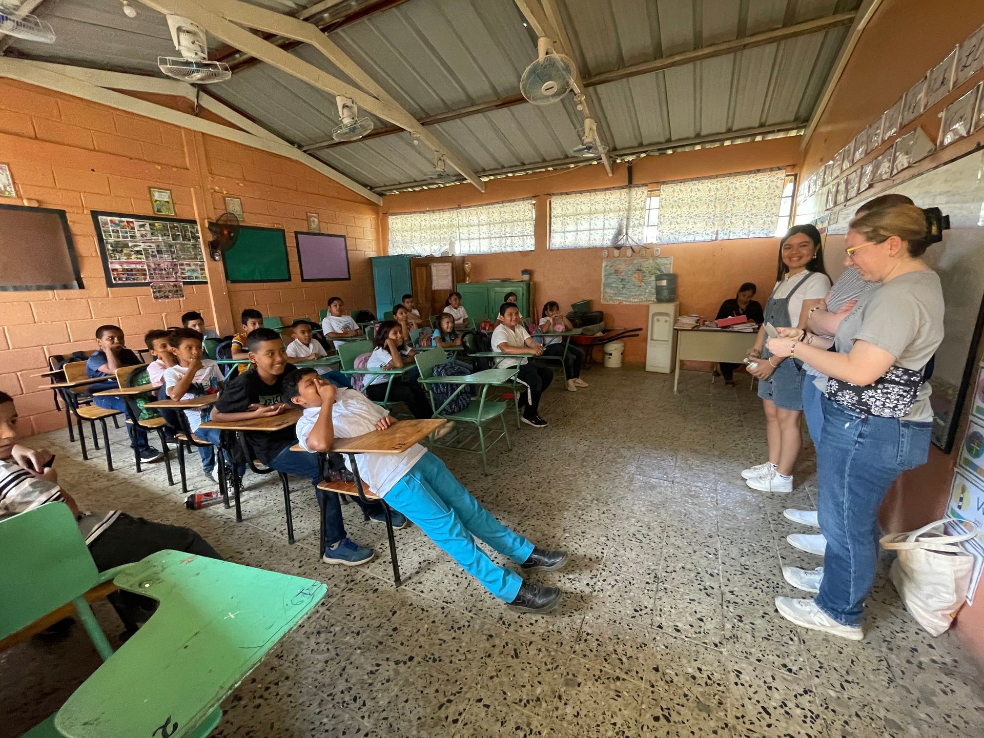 A group of children are sitting at desks in a classroom.