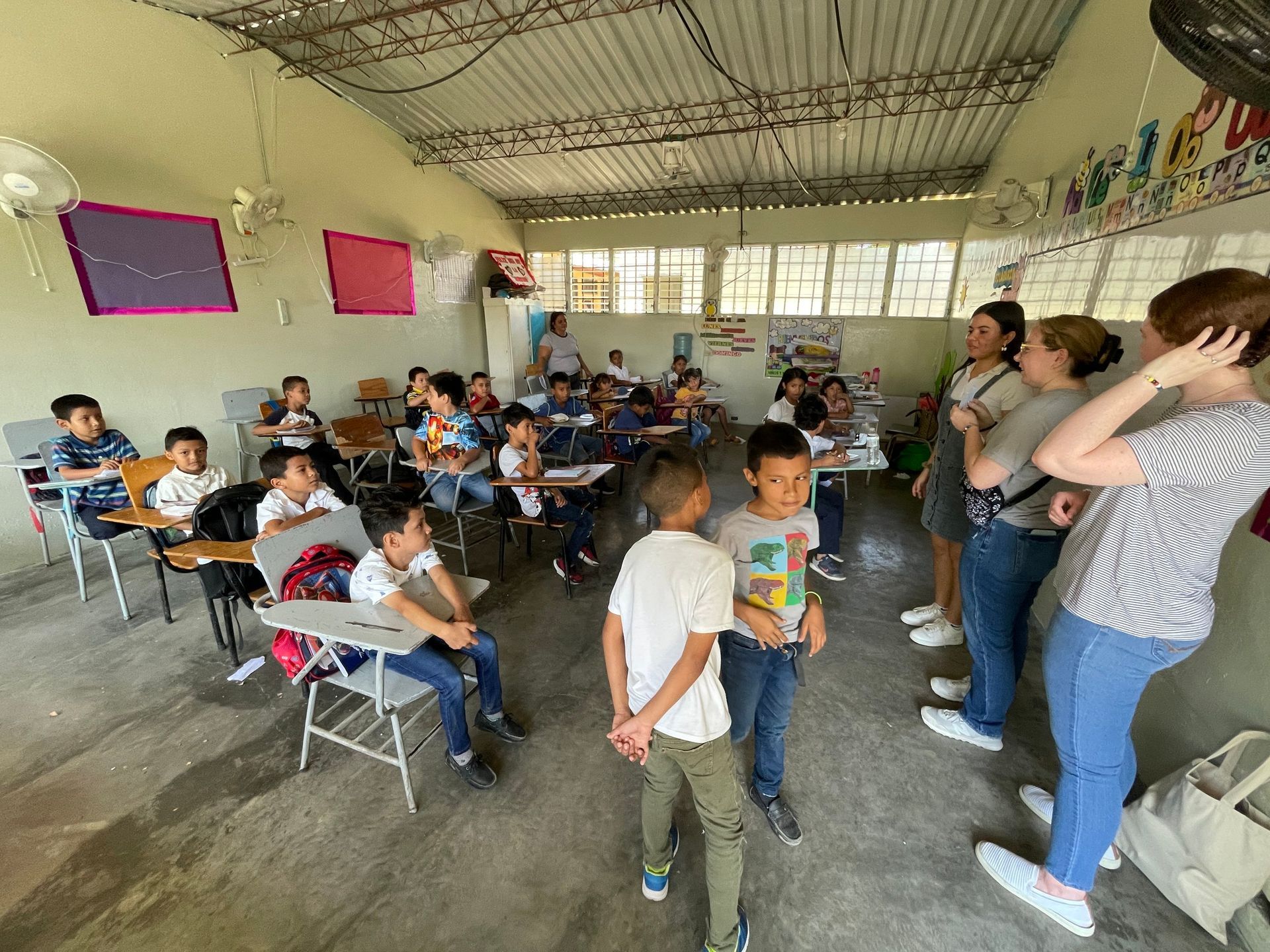 A group of children are sitting at desks in a classroom.