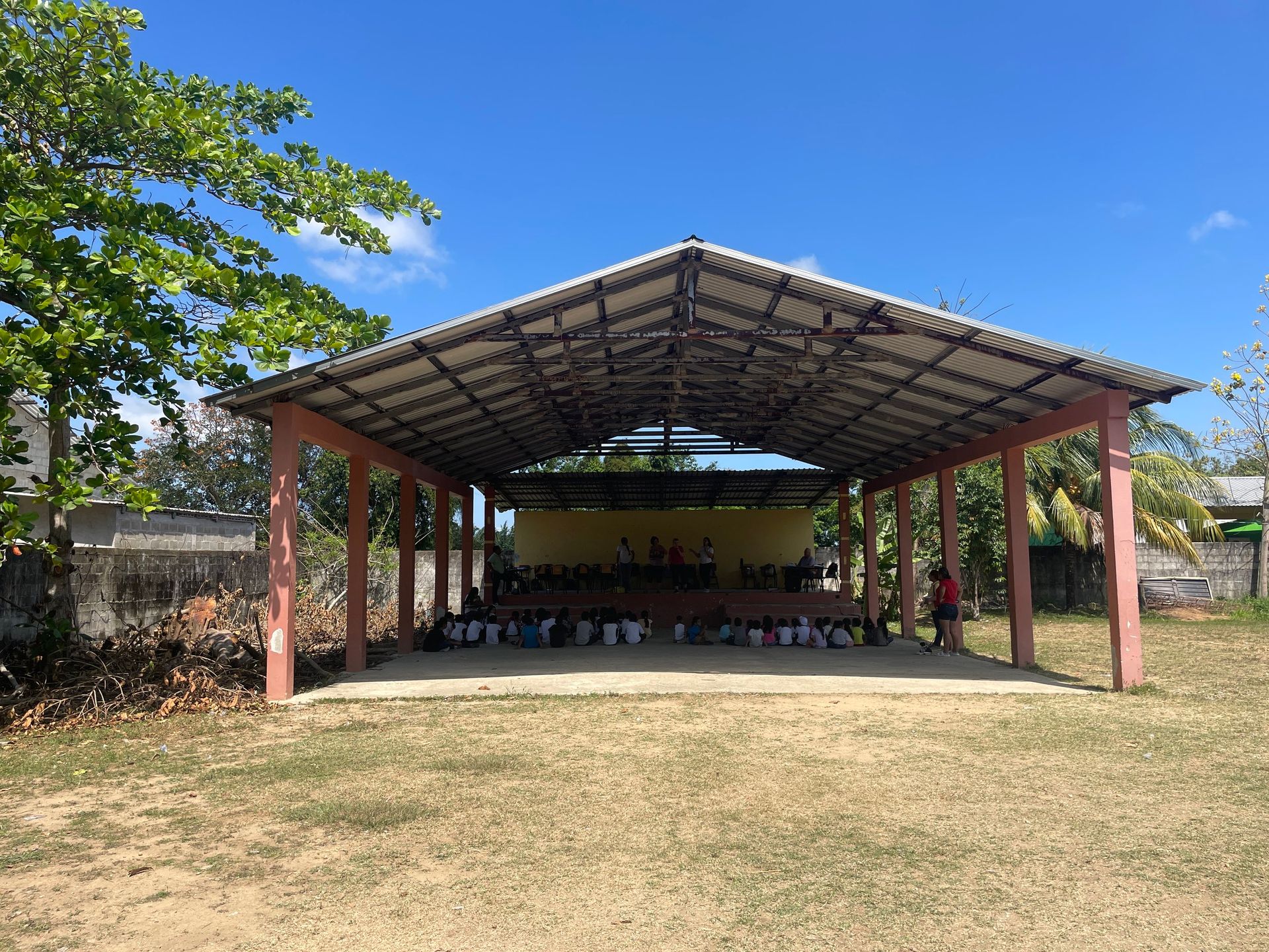 A large covered area with a stage in the middle of it