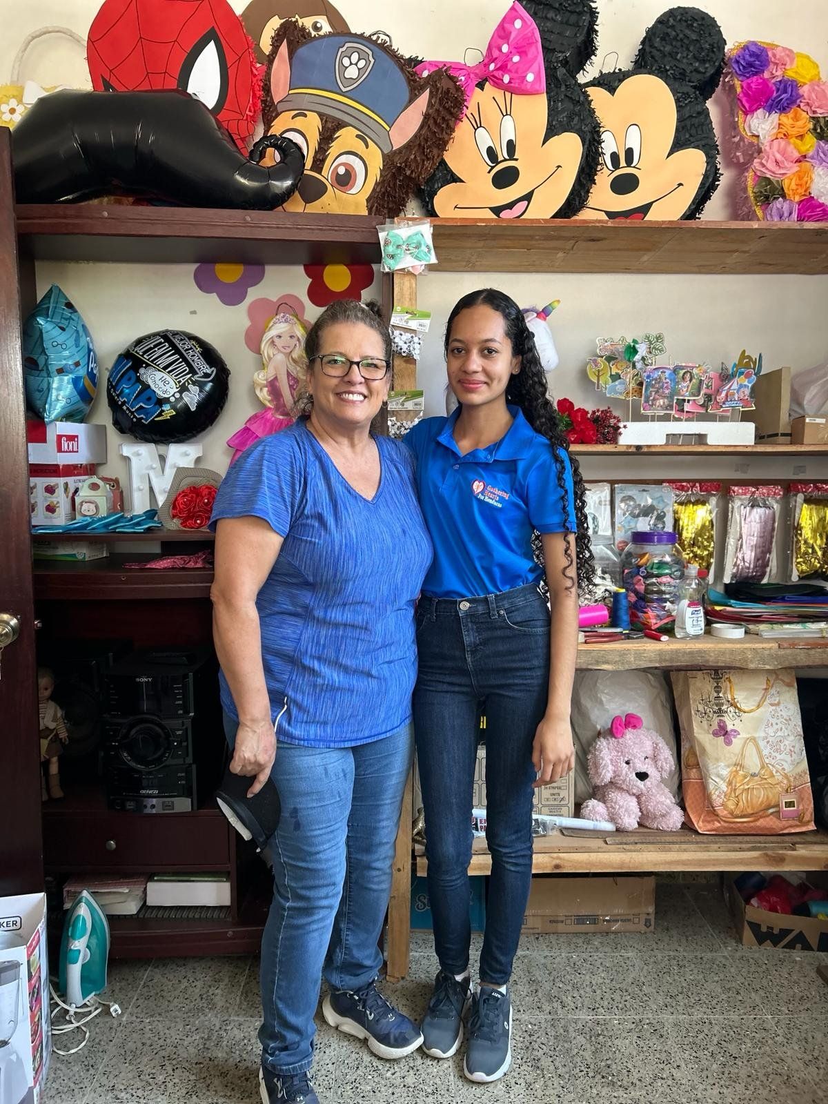 Two women are standing next to each other in a store.