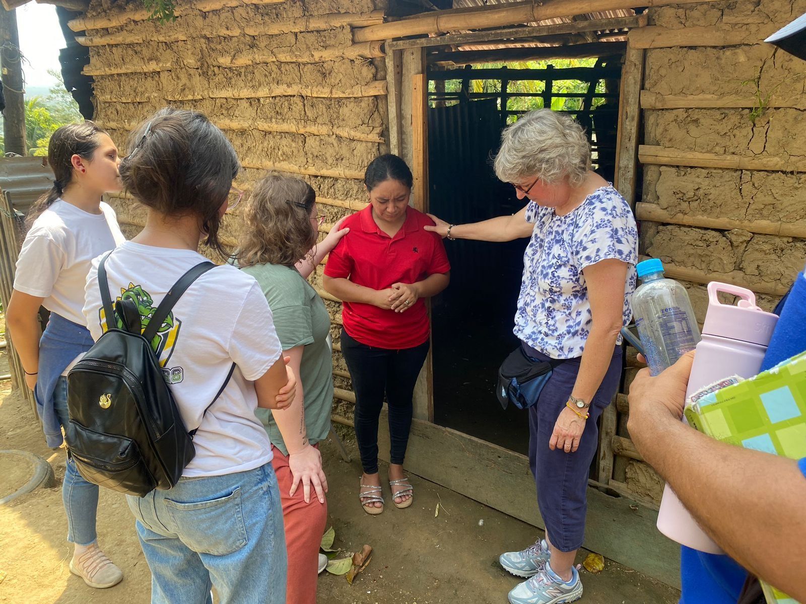 A group of people are standing in front of a building.