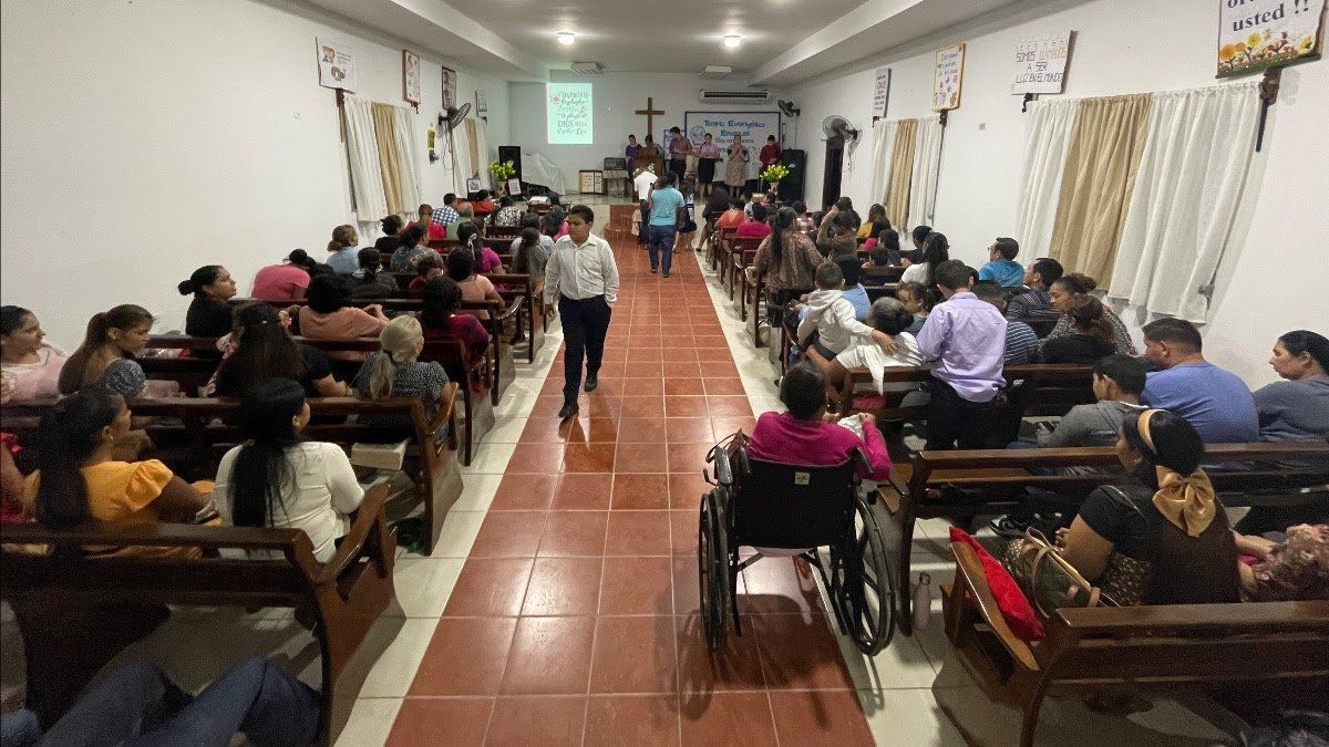 A large group of people are sitting in a church.