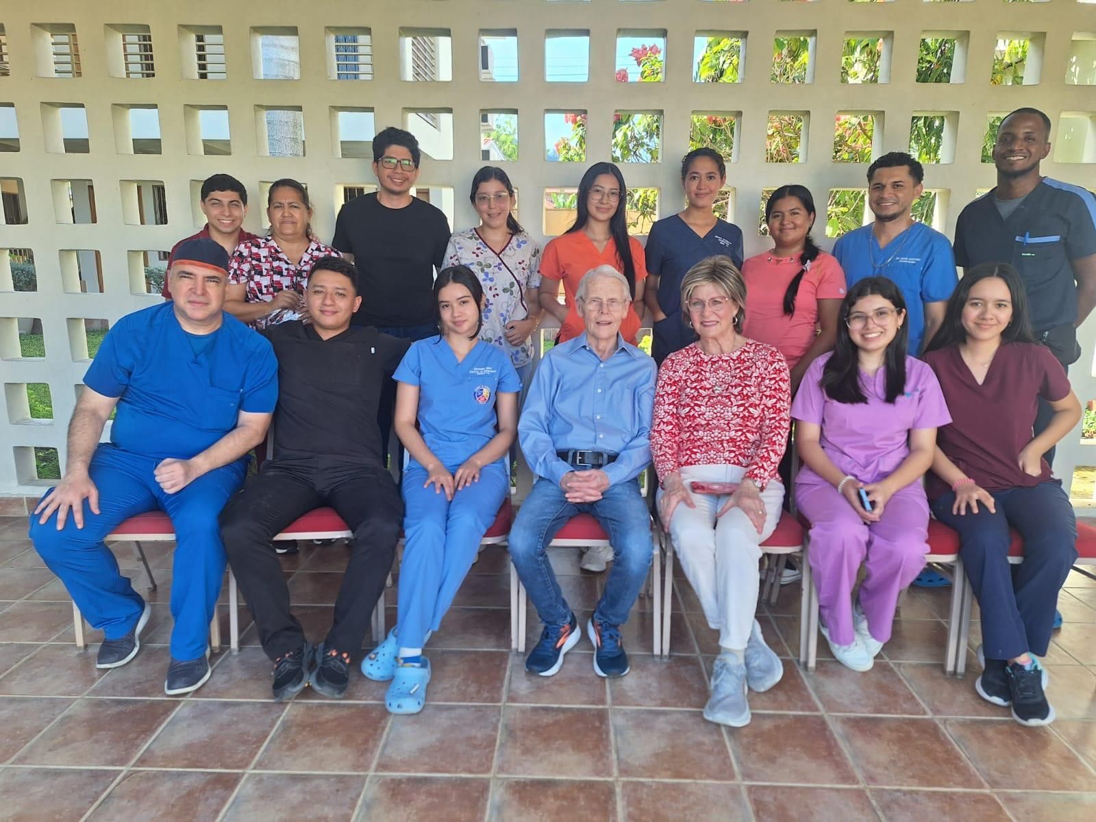 A group of people in scrubs are posing for a picture