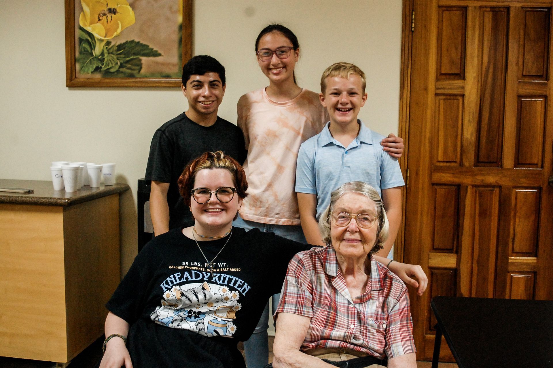 A group of people are posing for a picture in a room.