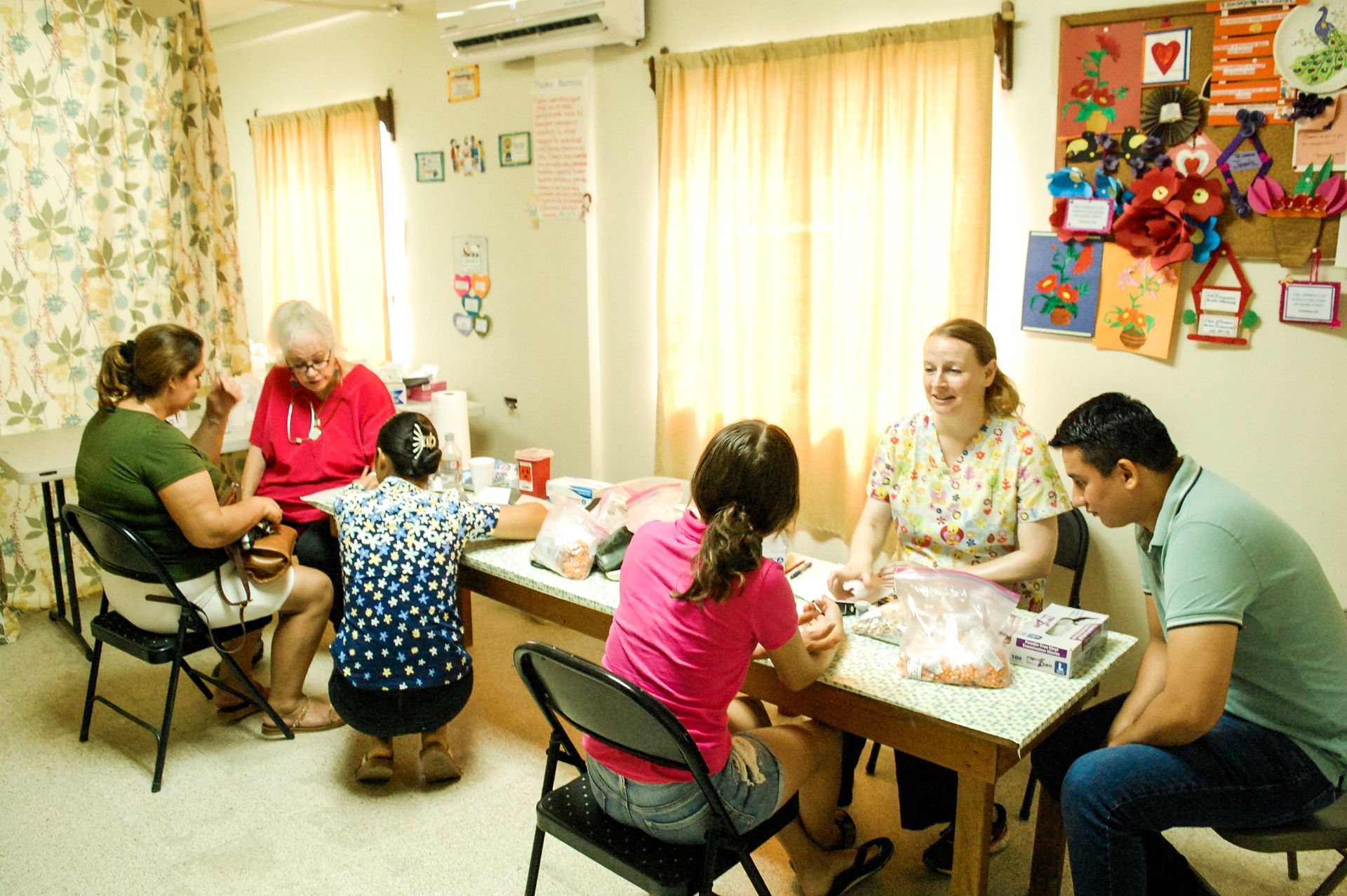 A group of people are sitting around a table in a room