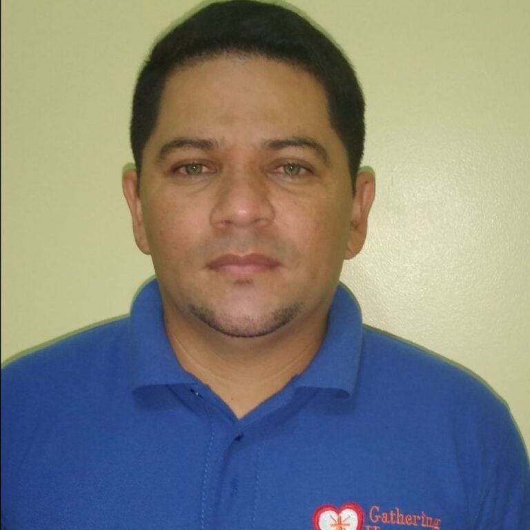 A man wearing a blue shirt that says gathering