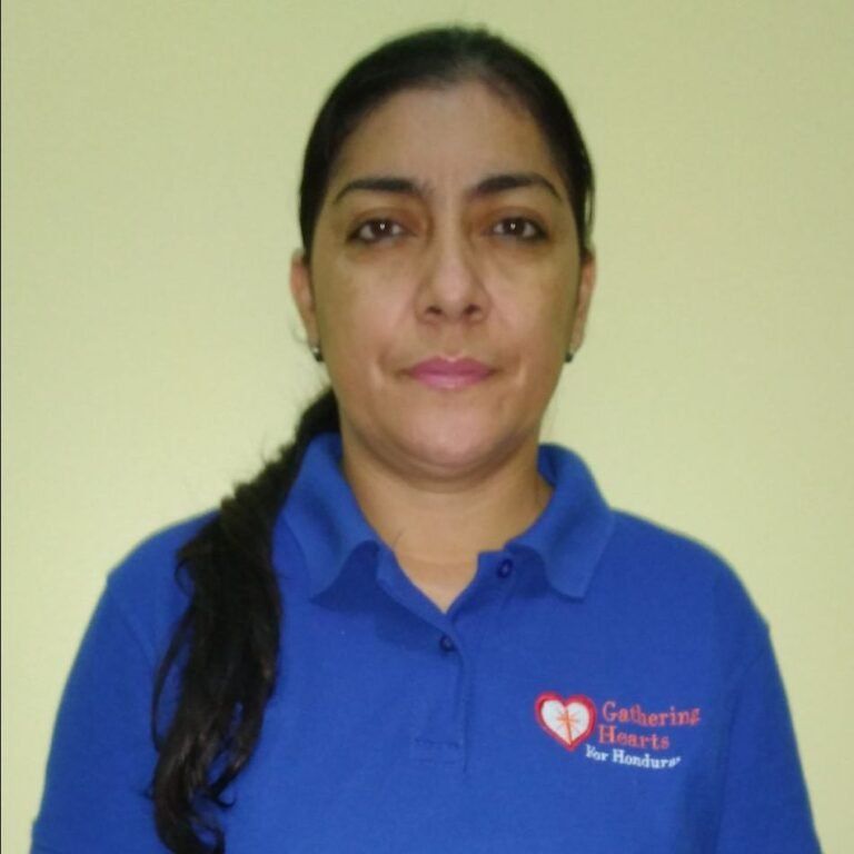 A woman wearing a blue shirt that says gathered hearts