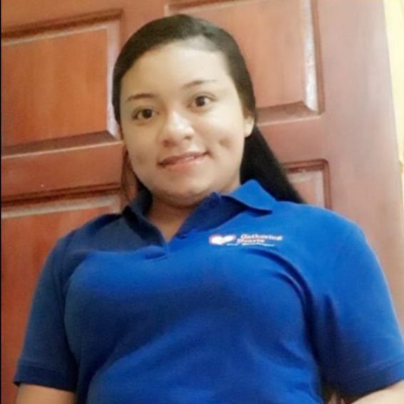 A woman wearing a blue shirt with the word abc on it