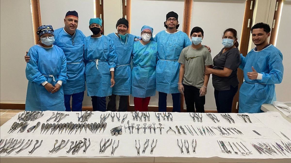 A group of doctors and nurses are posing for a picture.