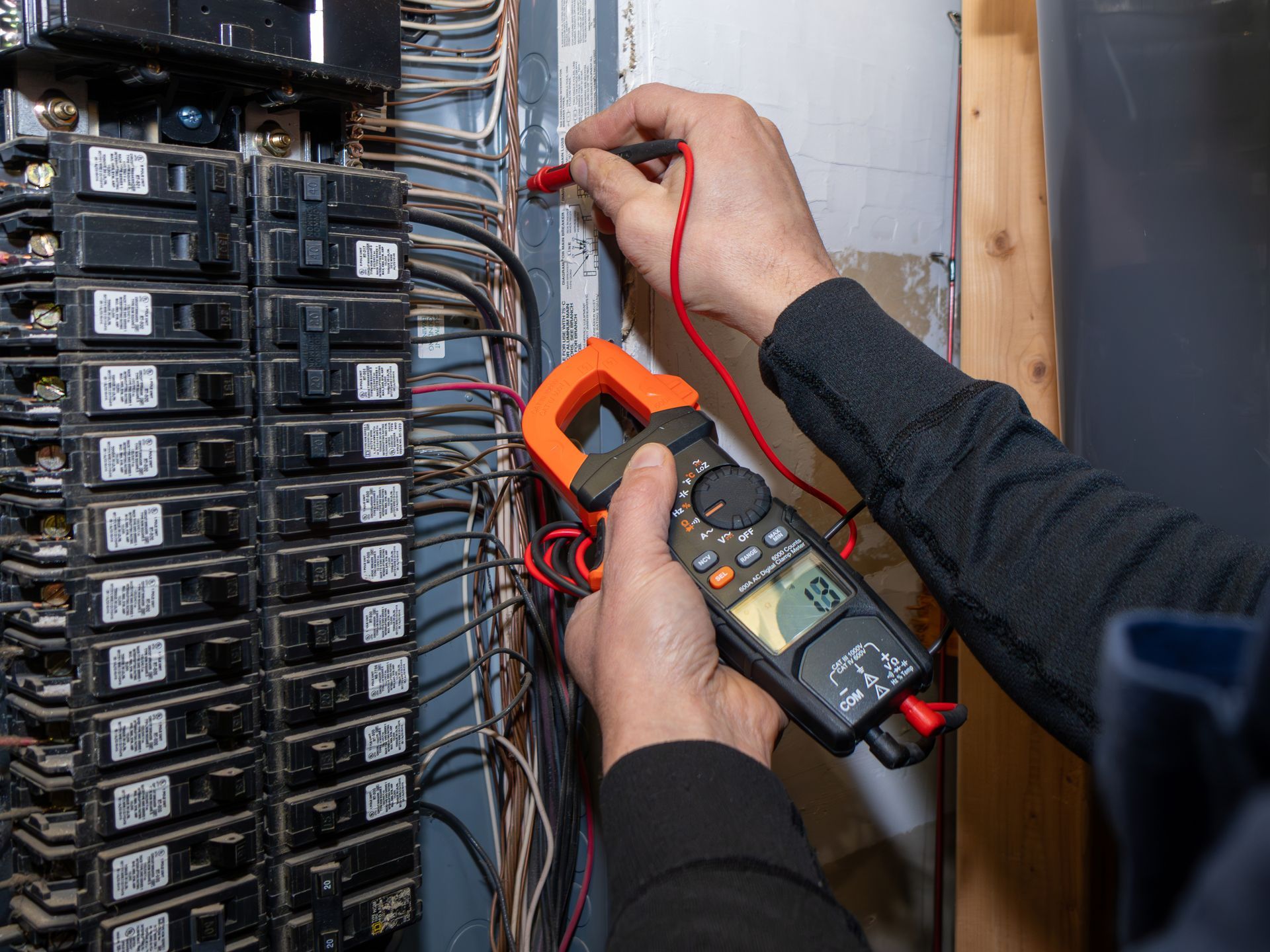 An electrical contractor is testing the home garage circuit breaker.