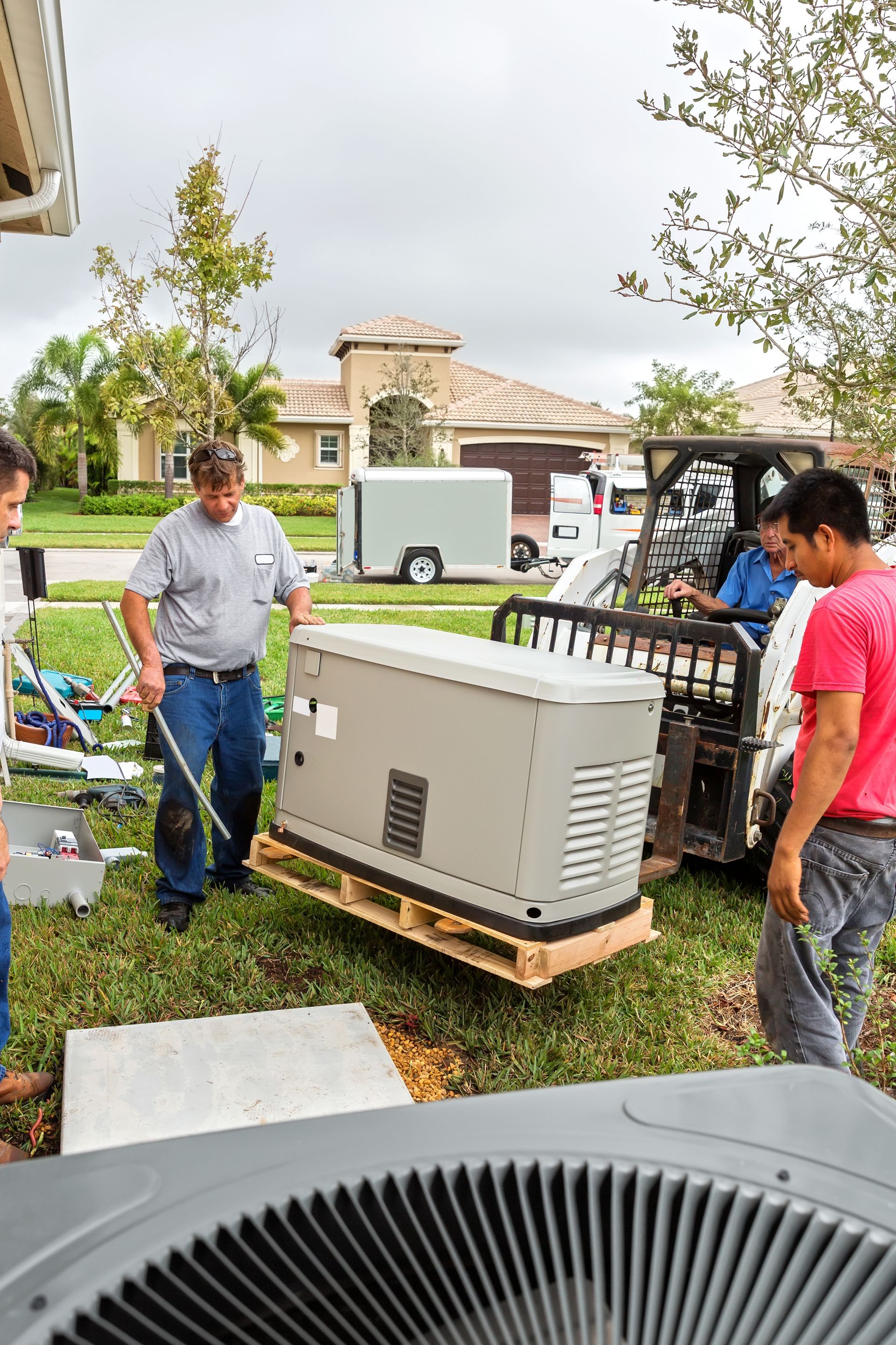 A group of men is installing a generator.