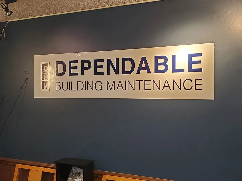 A sign on a wall that says dependable building maintenance