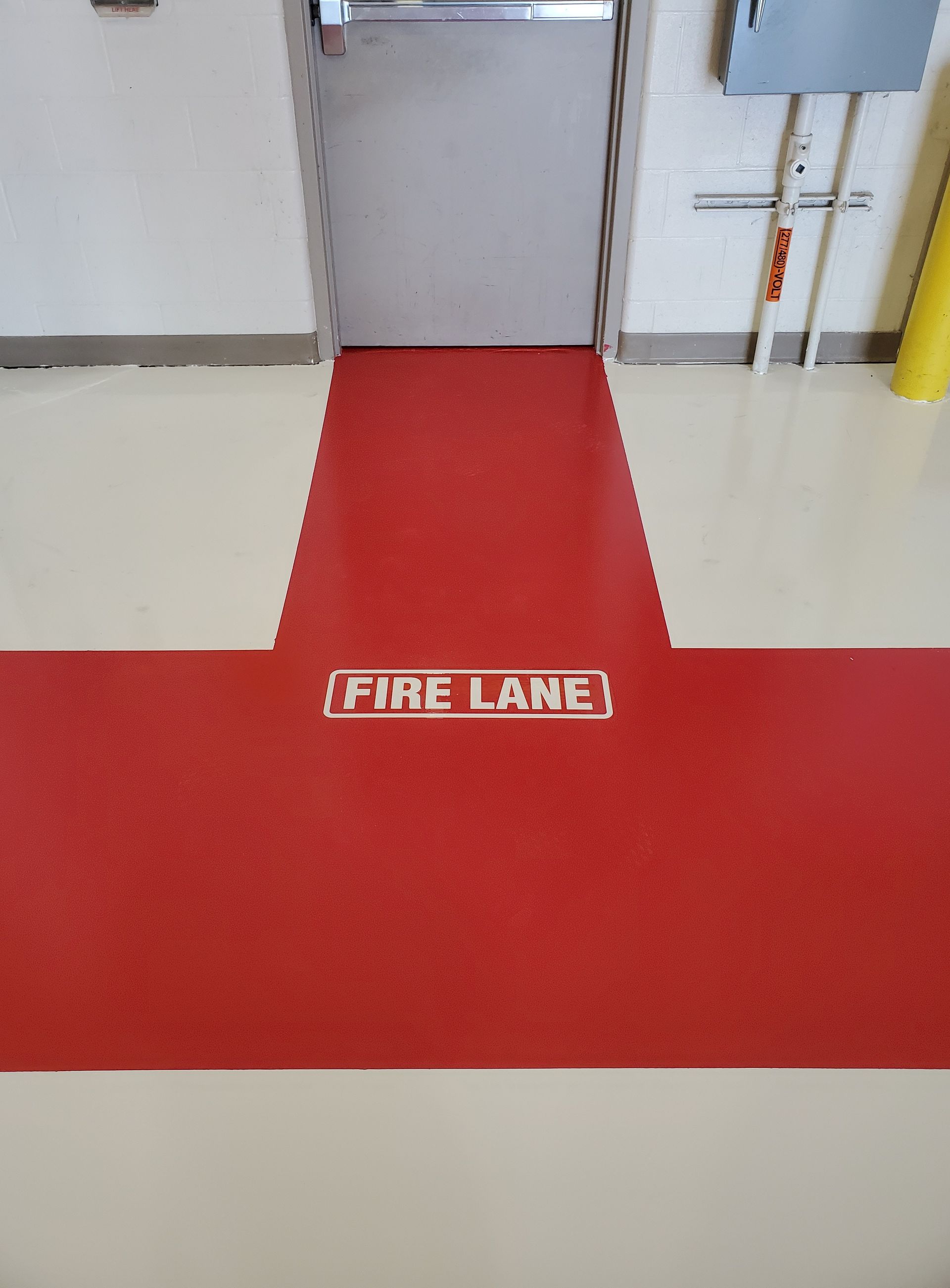 Aviation interior with solid-color epoxy floor including line striping and chemical-resistant urethane topcoat