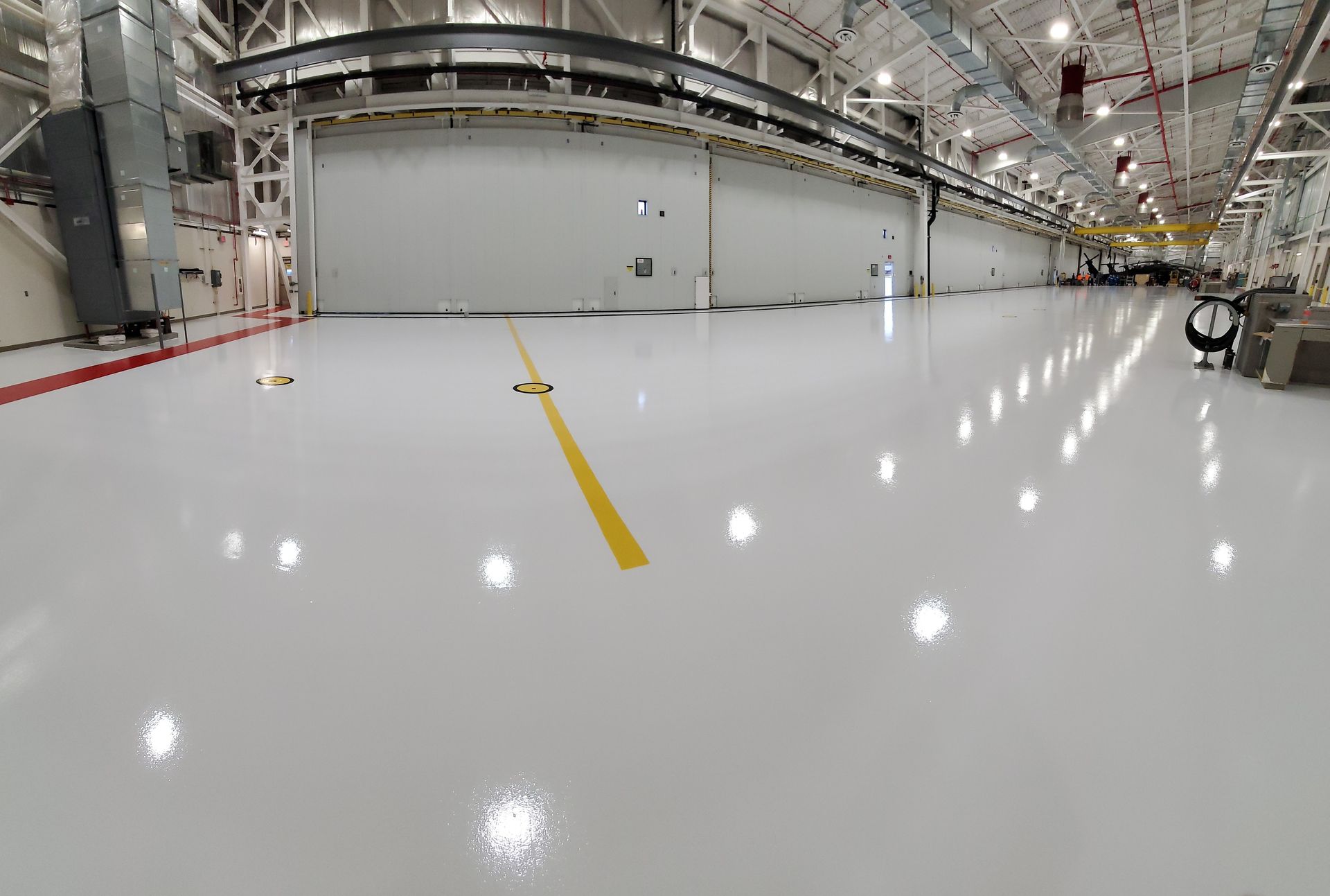 Aviation interior with solid-color epoxy floor including line striping and chemical-resistant urethane topcoat