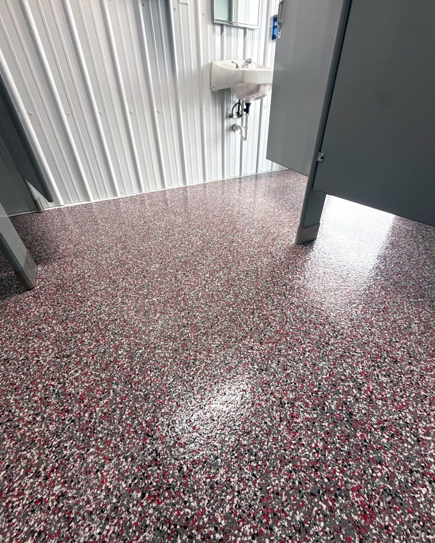 Interior of camp bathhouse with full-flake epoxy floor