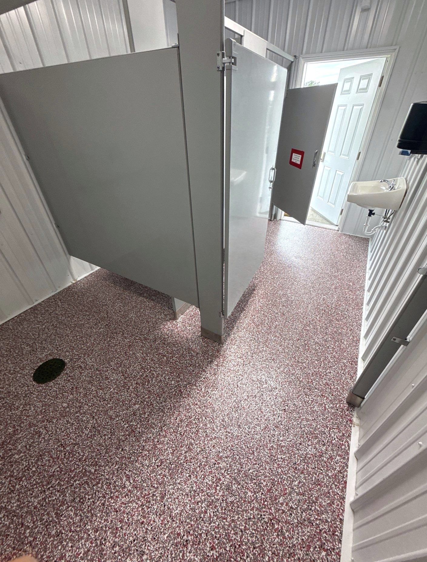Interior of camp bathhouse with full-flake epoxy floor