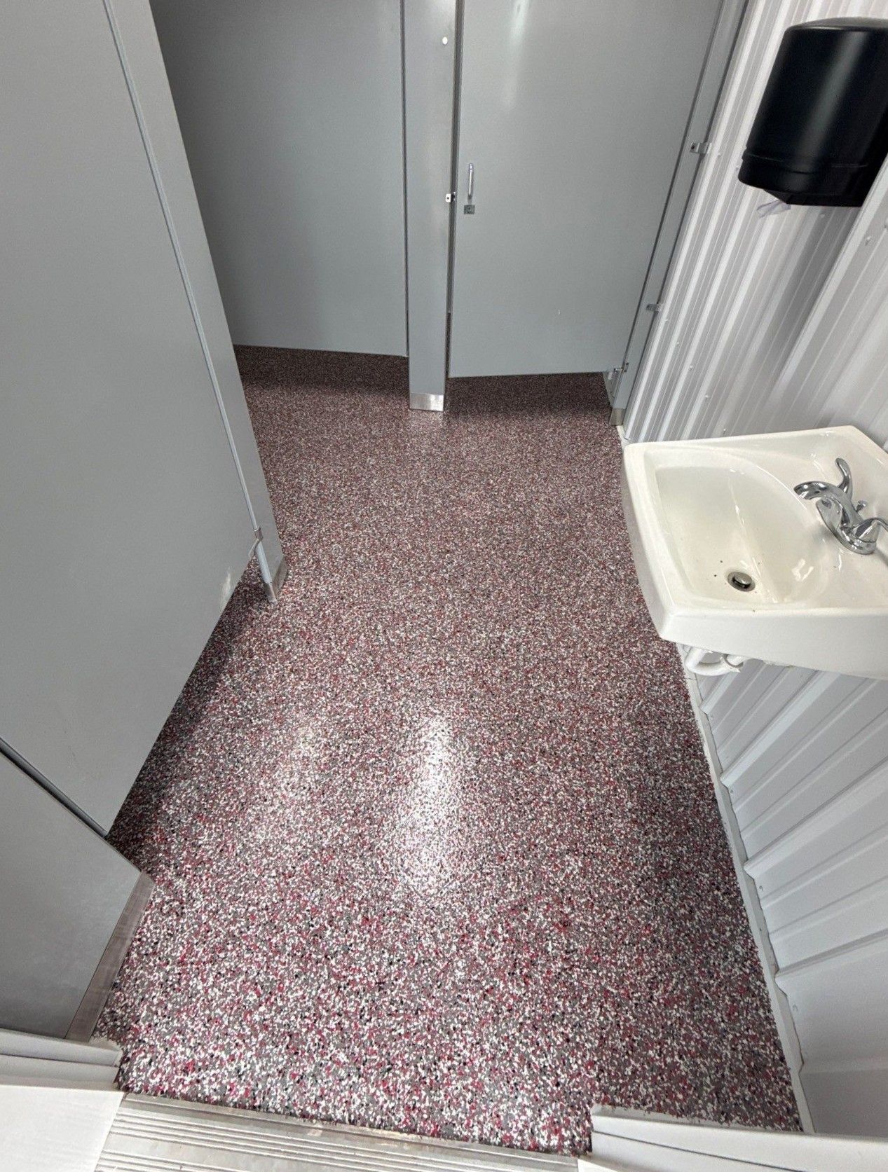 Interior of camp bathhouse with full-flake epoxy floor