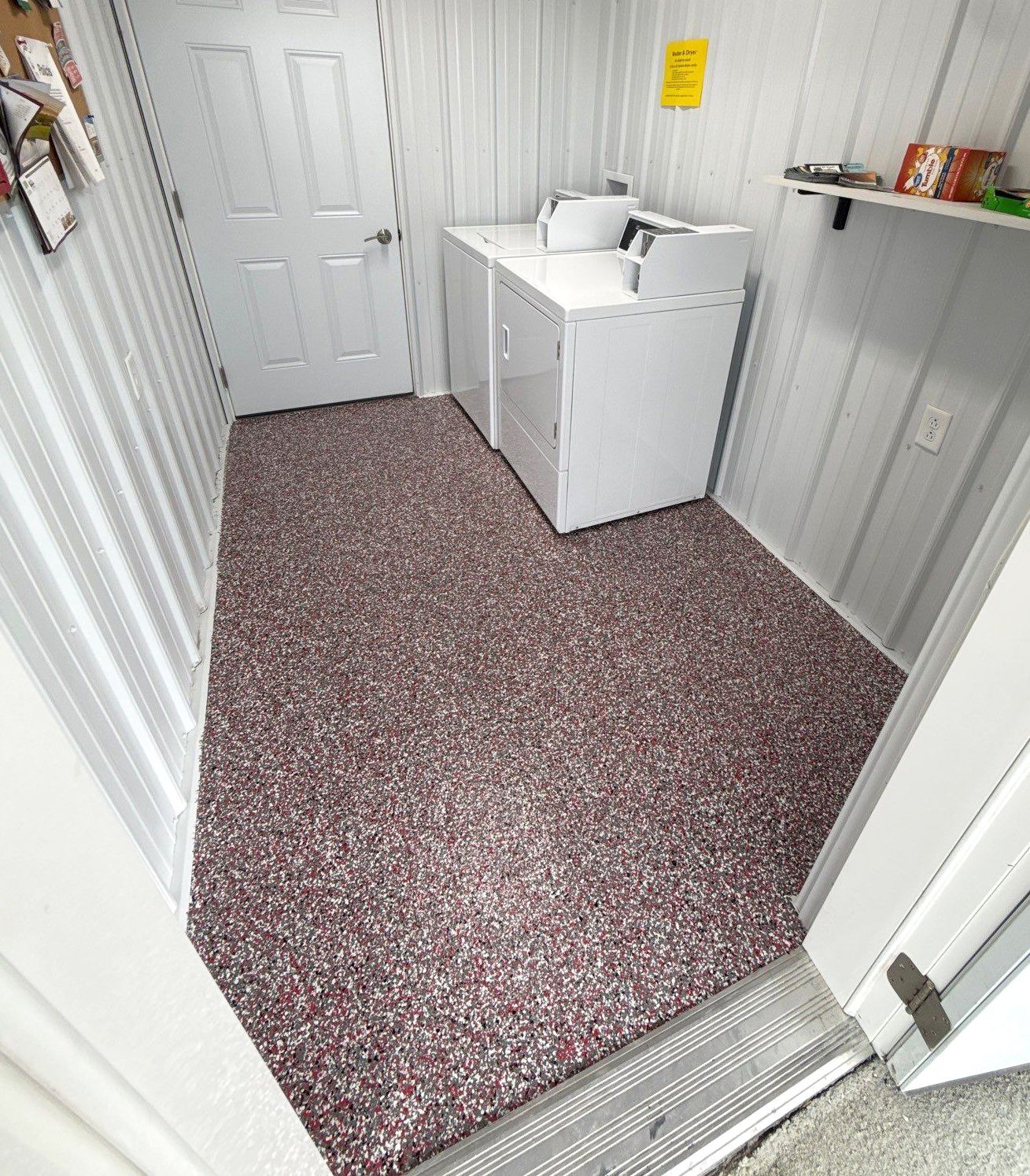 Interior of camp bathhouse with full-flake epoxy floor