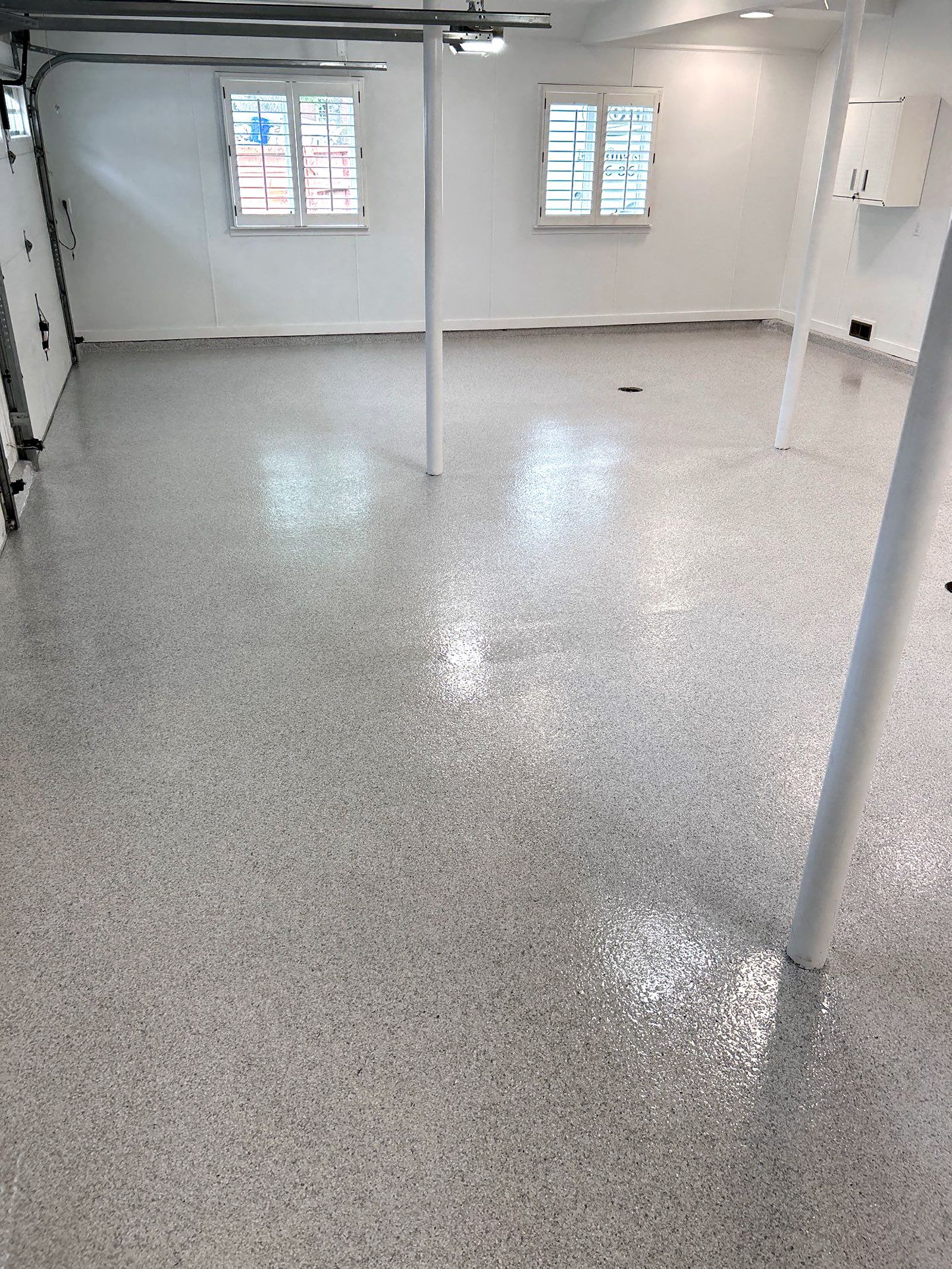 Home garage interior with full-flake epoxy floor