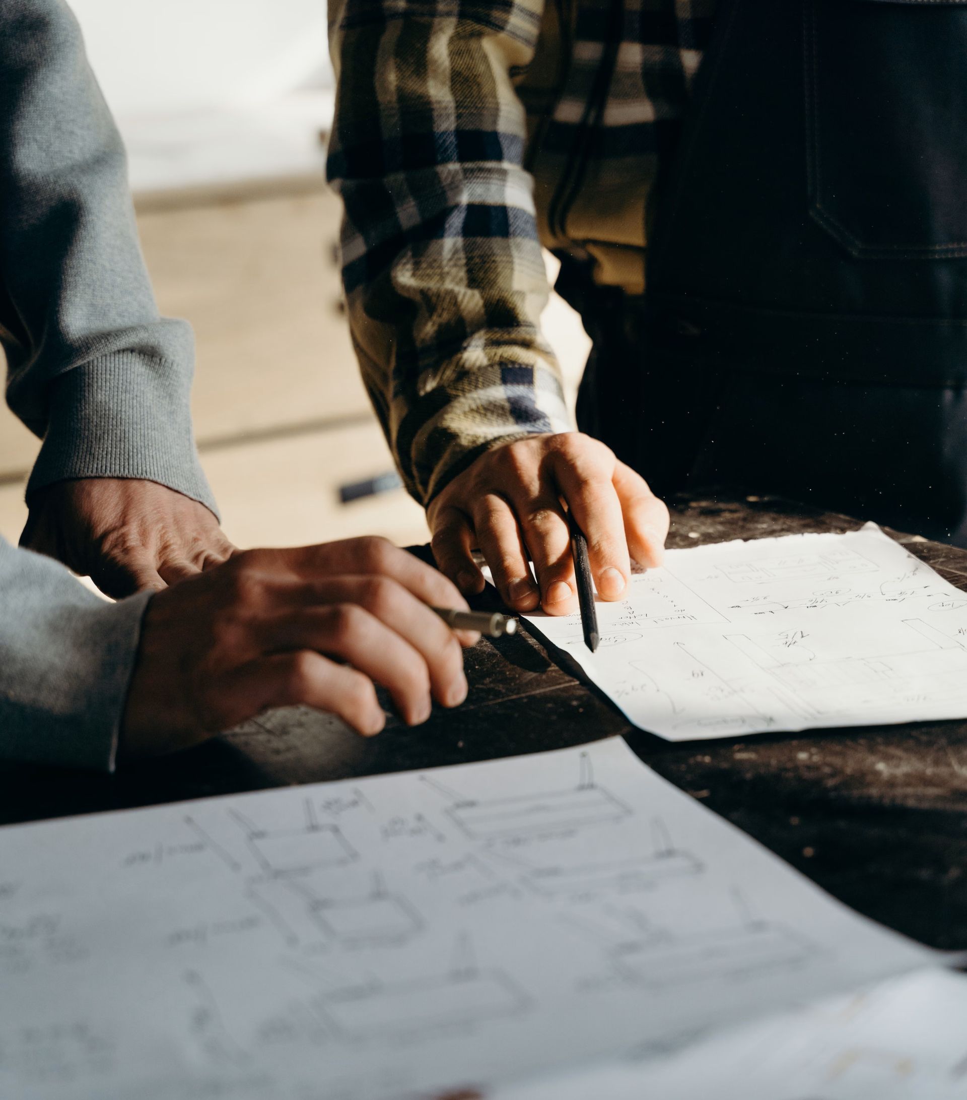 Talk to an epoxy floor expert - two people reviewing  plans