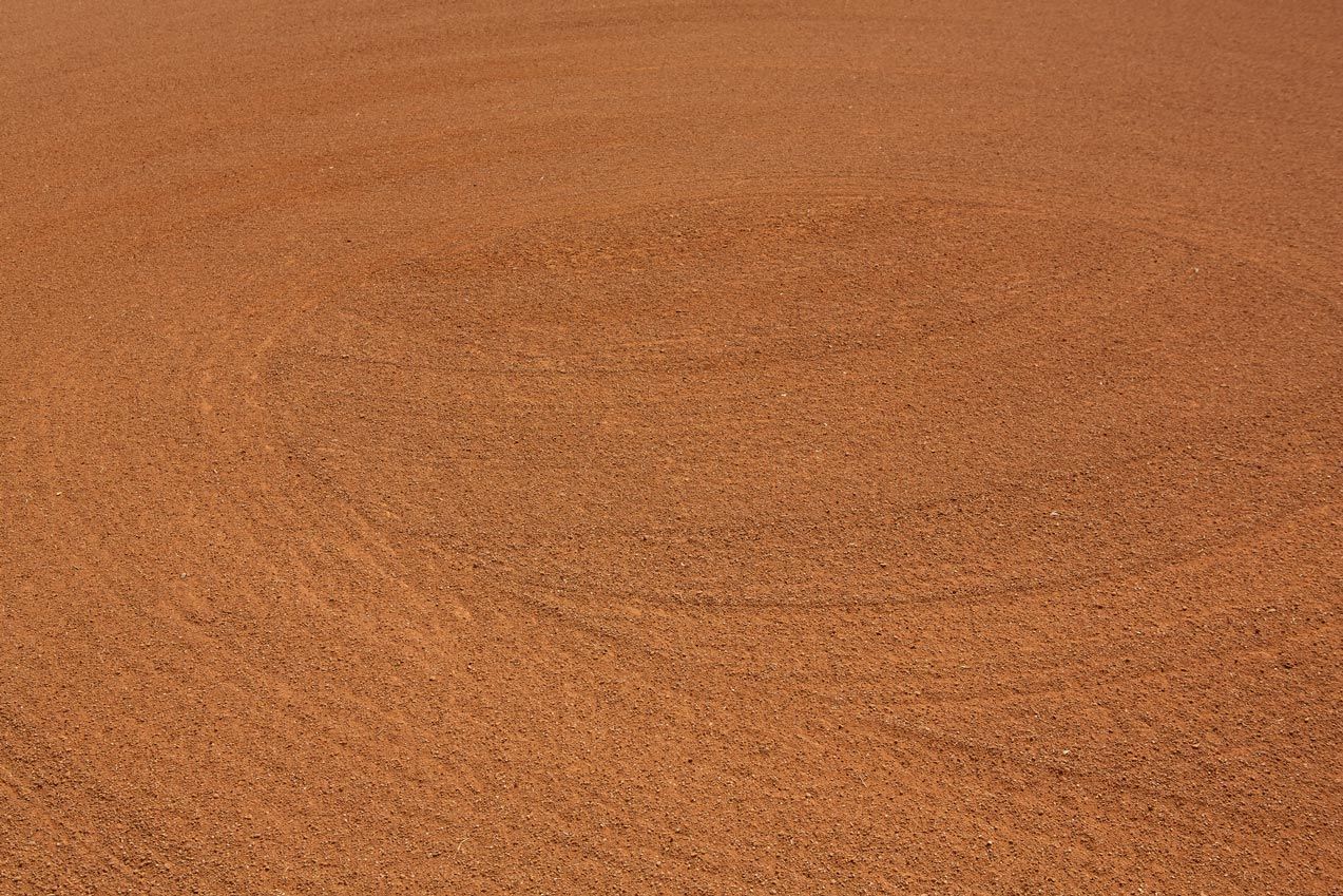 A close up of a brown surface with a lot of small stones.