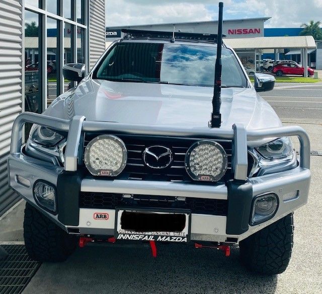 A Silver Mazda Truck Is Parked In Front Of A Nissan Store — Tech Tune Automotive and 4x4 ARB In Innisfail, QLD