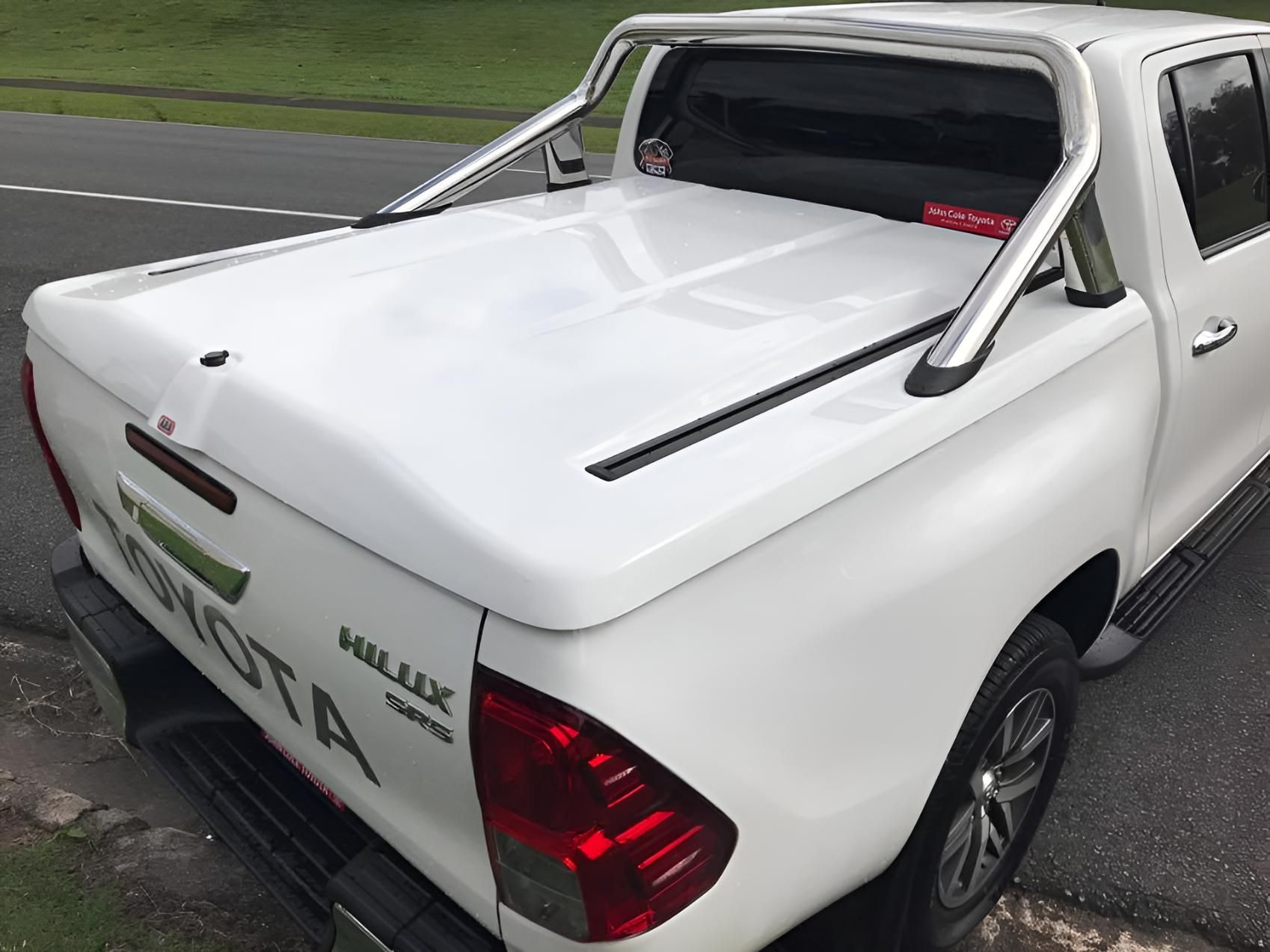 A White Toyota Hilux Truck Is Parked On The Side Of The Road — Tech Tune Automotive and 4x4 ARB In Innisfail, QLD