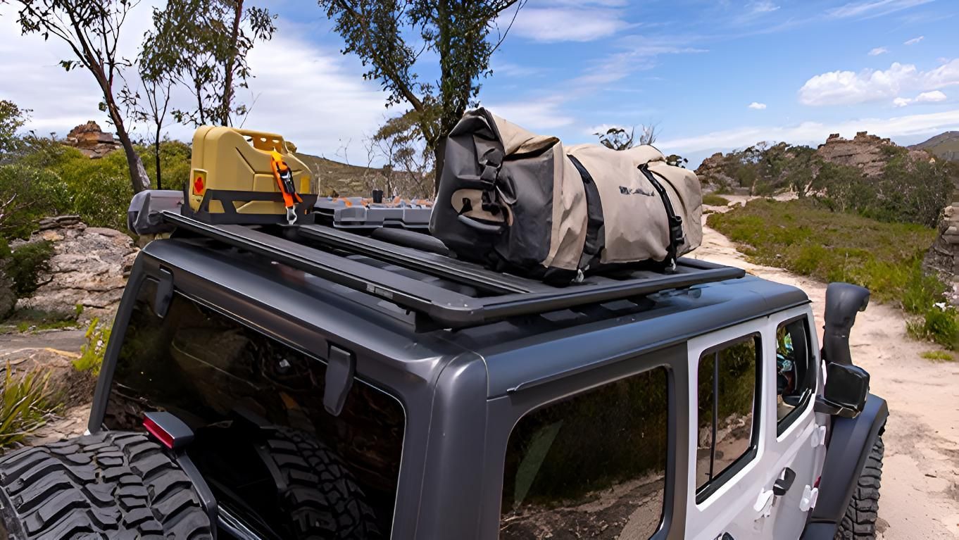 A Jeep With A Bag On The Roof Is Parked On A Dirt Road — Tech Tune Automotive and 4x4 ARB In Innisfail, QLD