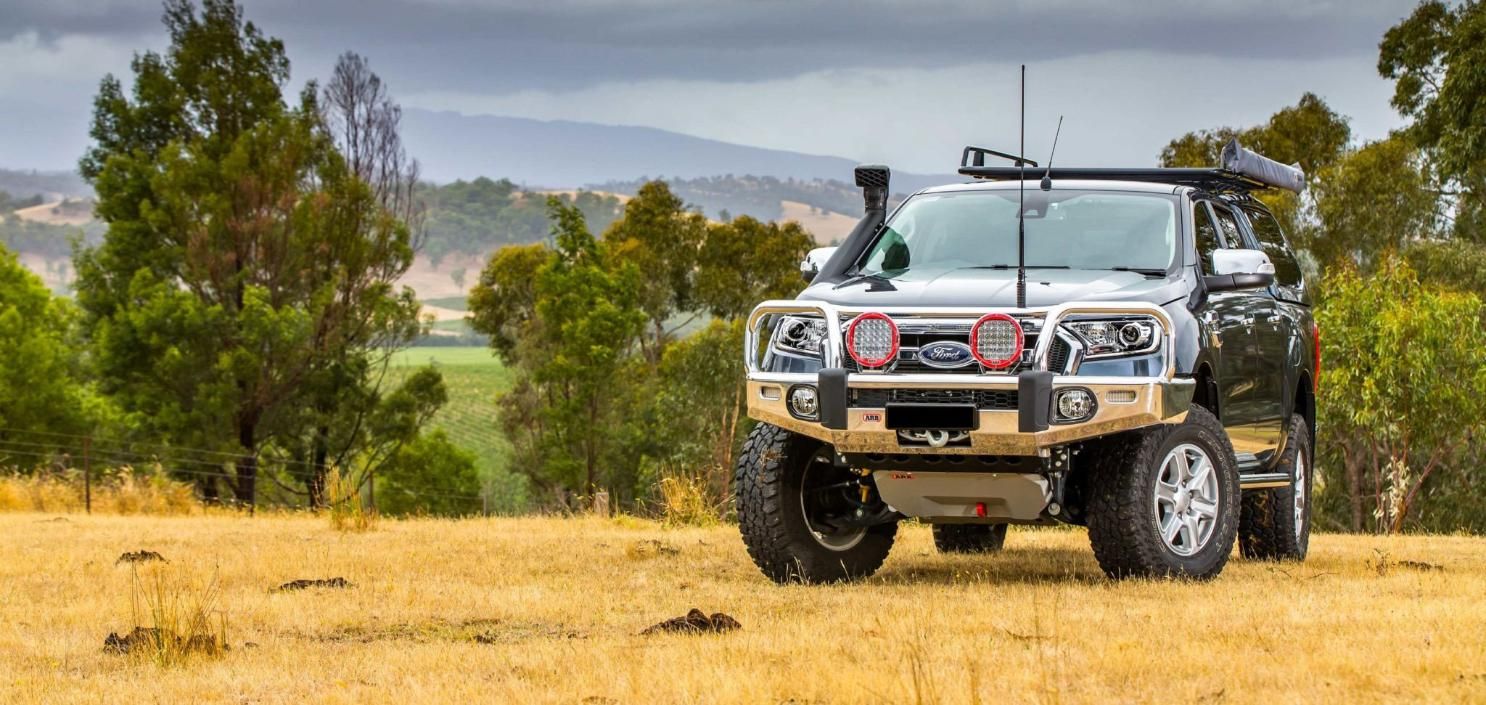 A Truck Is Parked In A Field With Trees In The Background — Tech Tune Automotive and 4x4 ARB In Innisfail, QLD