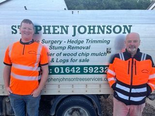 A man standing in front of a truck that says johnson