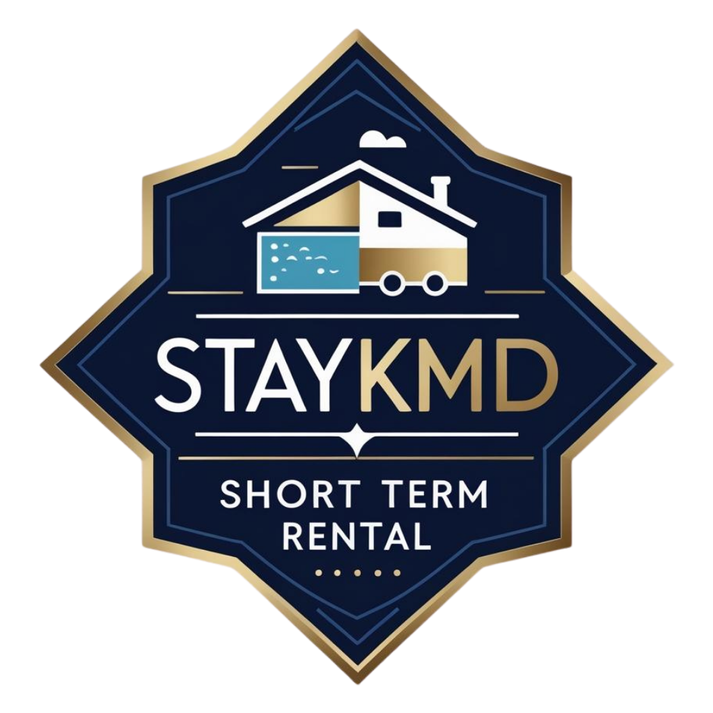 STAYKMD short-term rental logo with a house and trailer in navy blue and gold