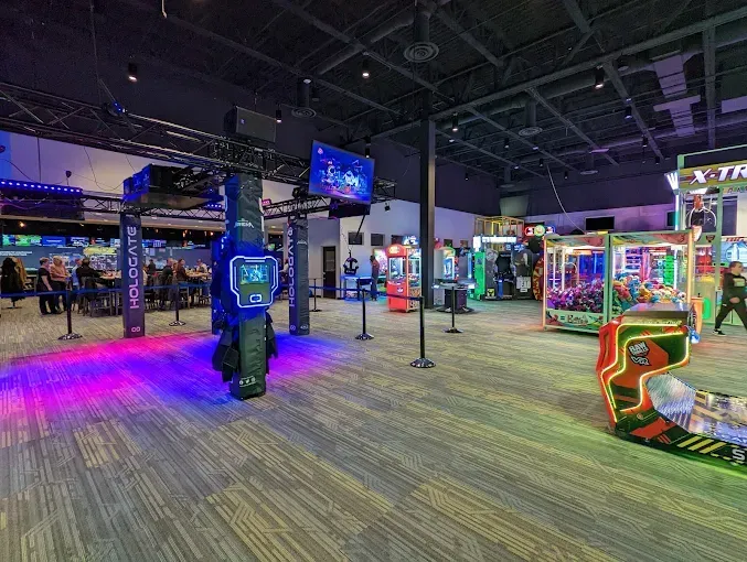 Arcade with colorful game machines and glowing lights on a carpeted floor