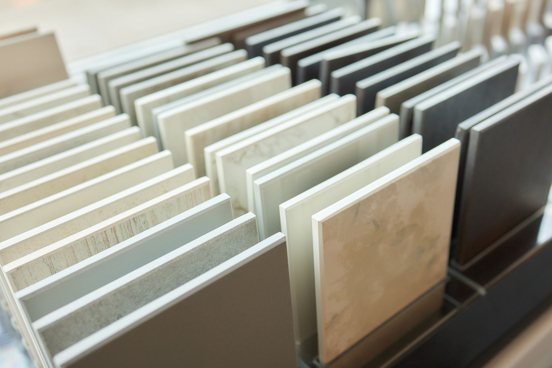 Display of various ceramic tile samples in different colors and textures. Display of various ceramic tile samples in different colors and textures.