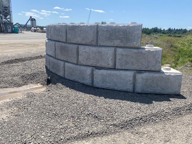 A large concrete block is sitting on top of a pile of gravel.