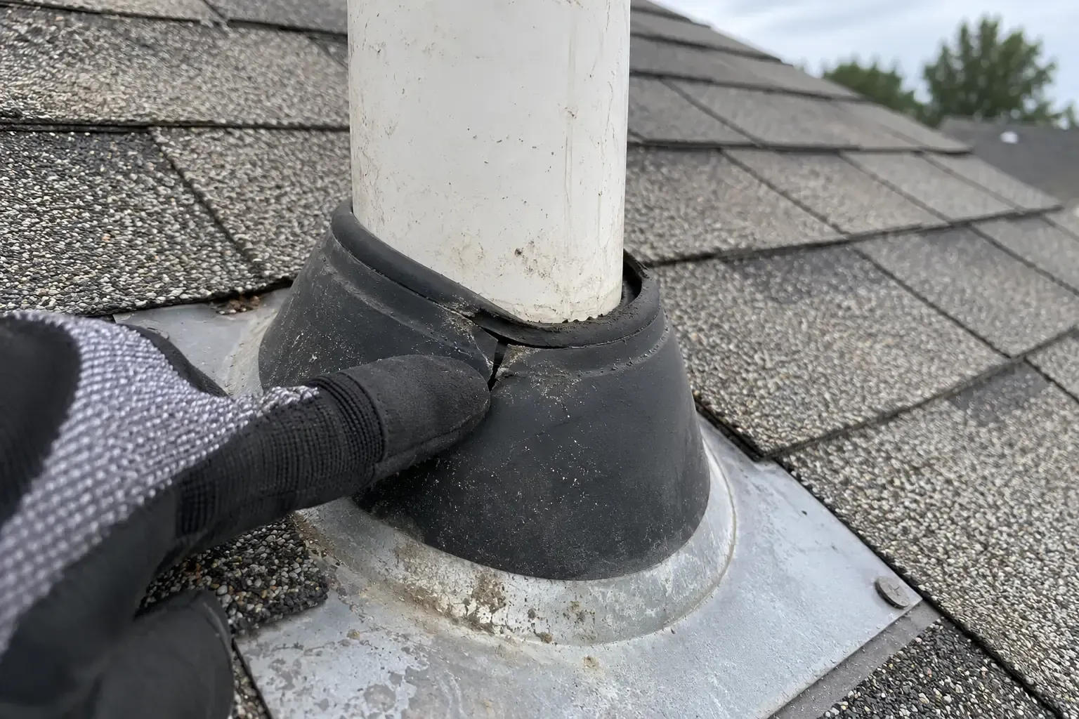 Worn rubber pipe boot with a split near the pipe