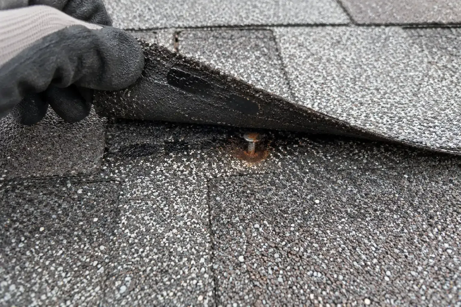 Nail head working loose under a shingle, marked in chalk