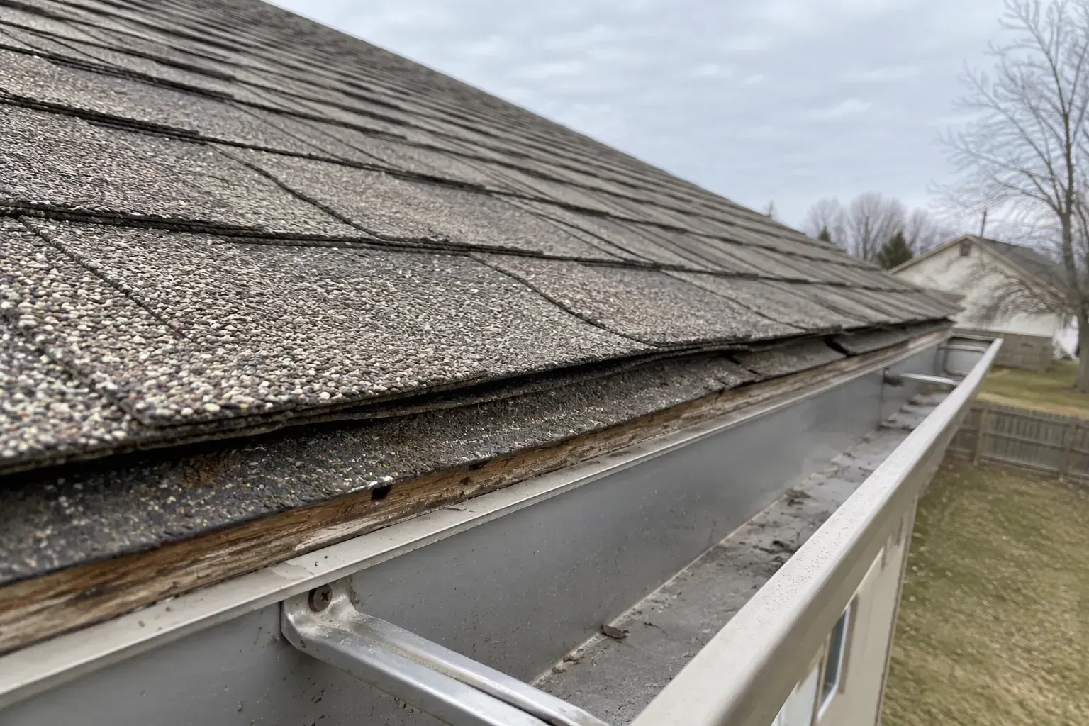 Two stacked layers of shingles visible at the edge of a roof