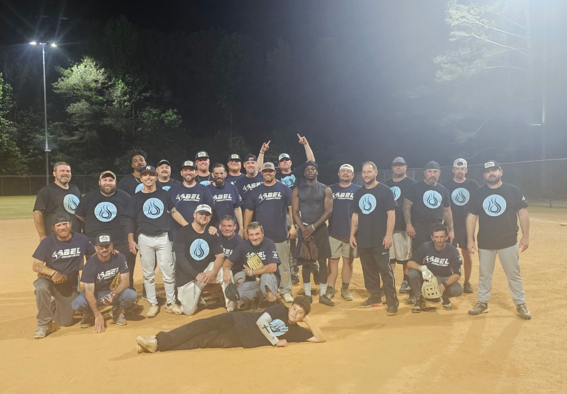 Abel Electric softball team taking a team picture together