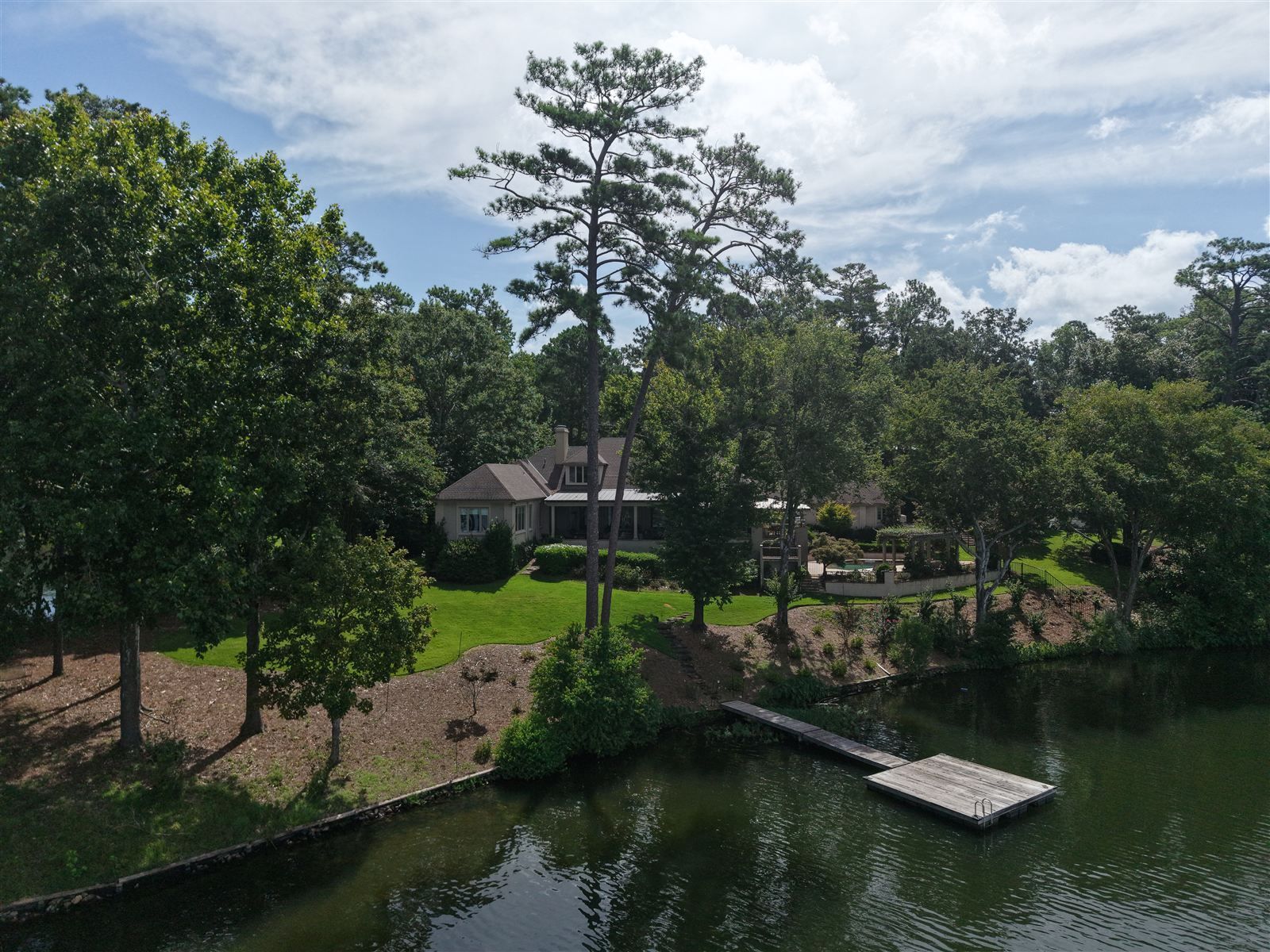 Lake Martin lake home with a boat dock, aerial view, Dadeville AL
