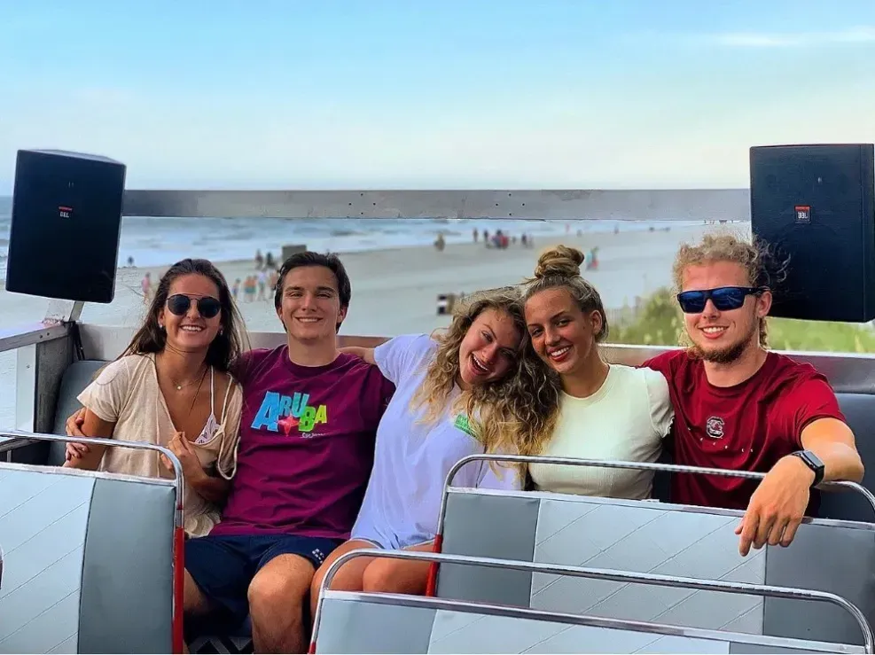 A group of people are posing for a picture on a boat.
