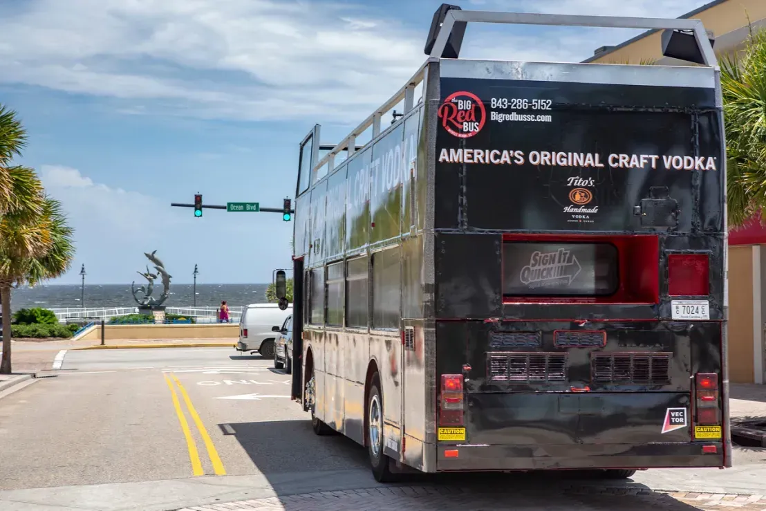 A double decker bus is parked on the side of the road.
