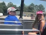 A man and a girl are sitting on a bus.