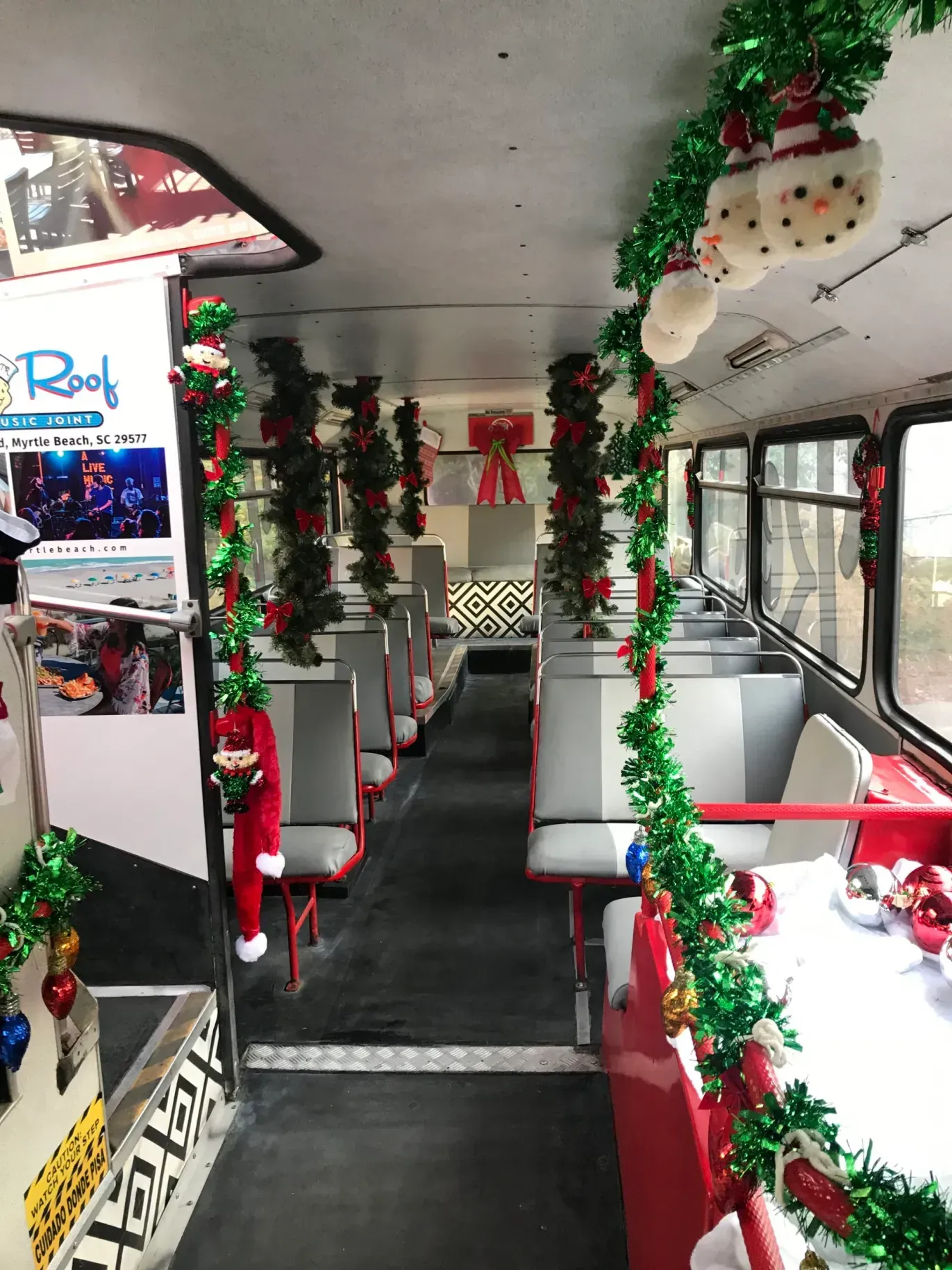 The inside of a bus decorated with christmas decorations