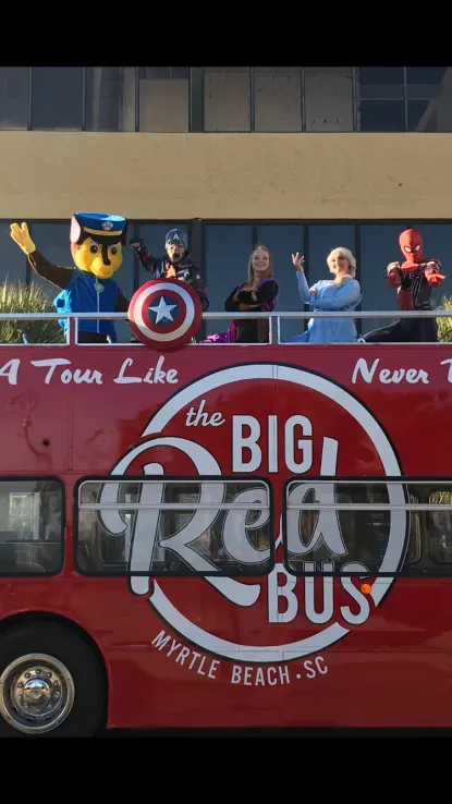 A red double decker bus that says a tour like the big red bus