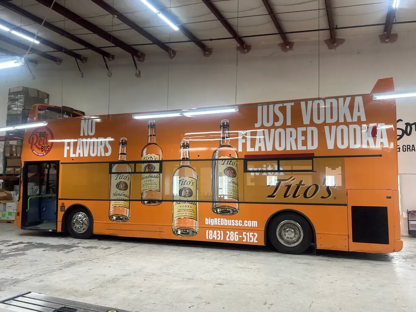 A double decker bus that says just vodka flavored vodka