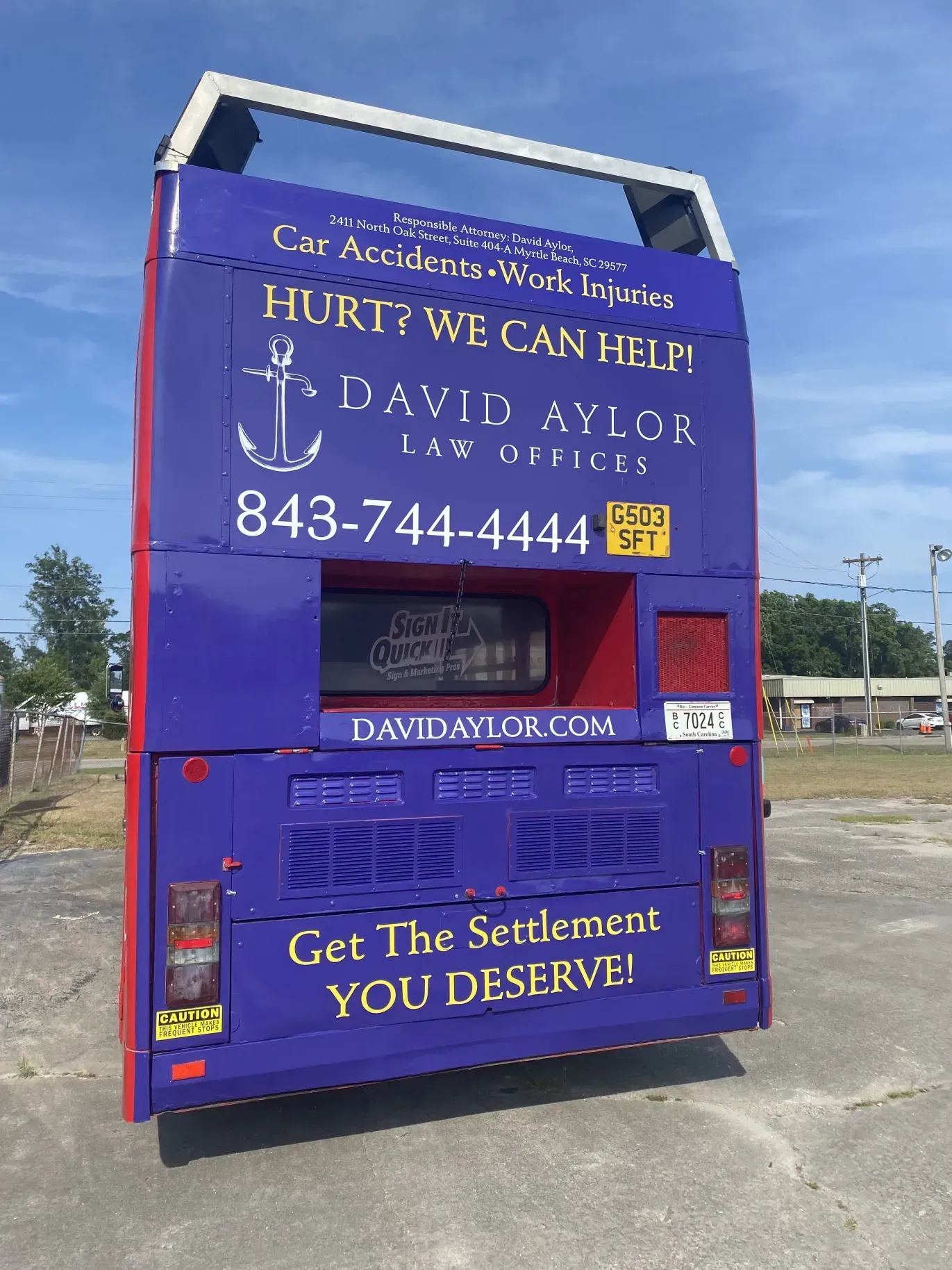 The back of a double decker bus advertising david aylor law offices