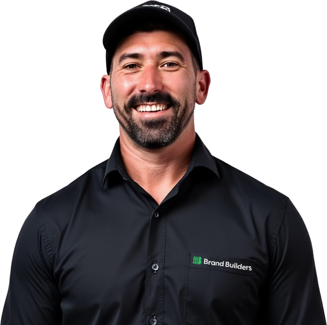 Smiling man in black cap and shirt against a white background