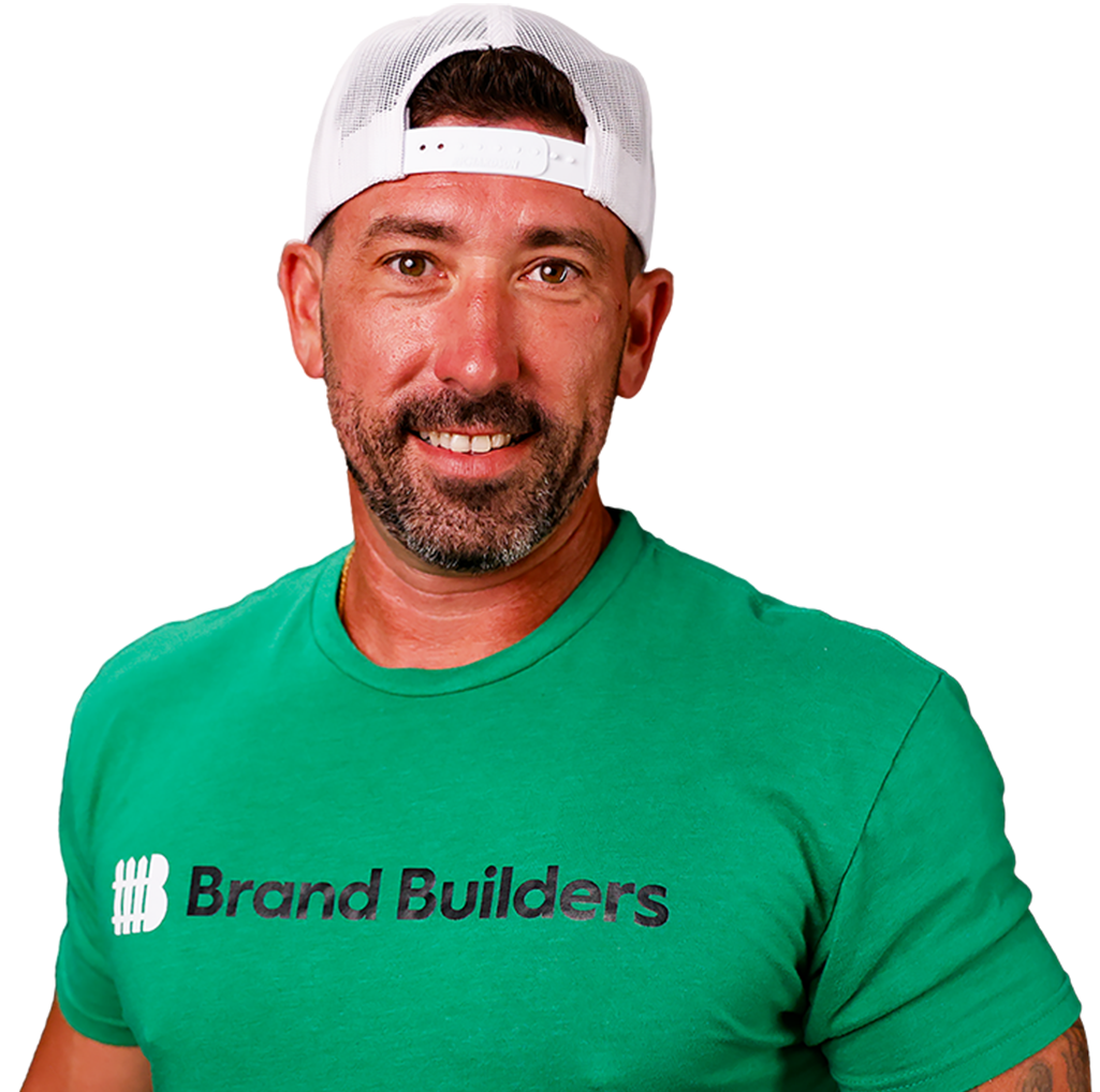 Smiling man in a white backward cap and green Brand Builders T-shirt on a white background