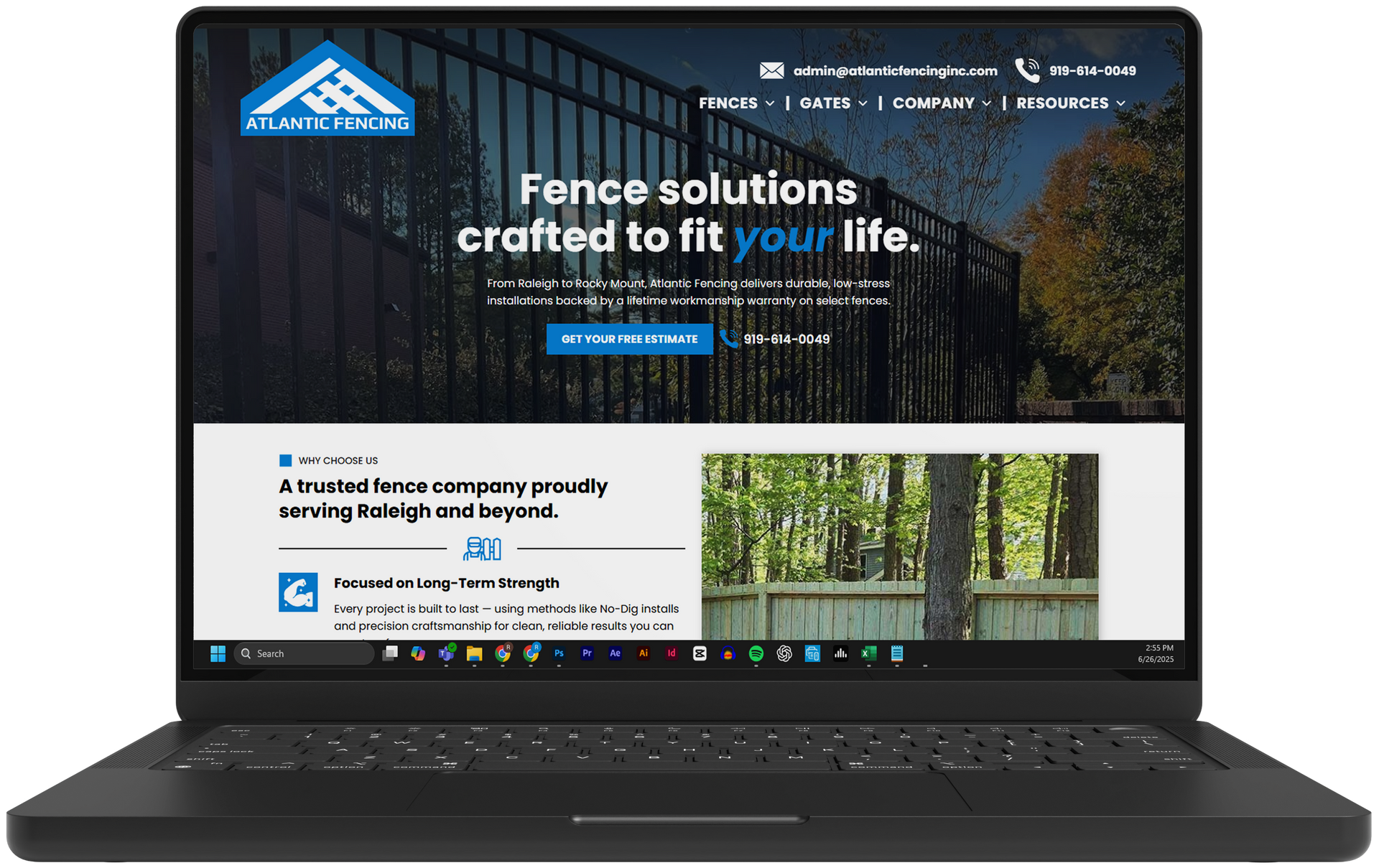 Laptop displaying a fence company website with a forest background and bold “Fence solutions” headline